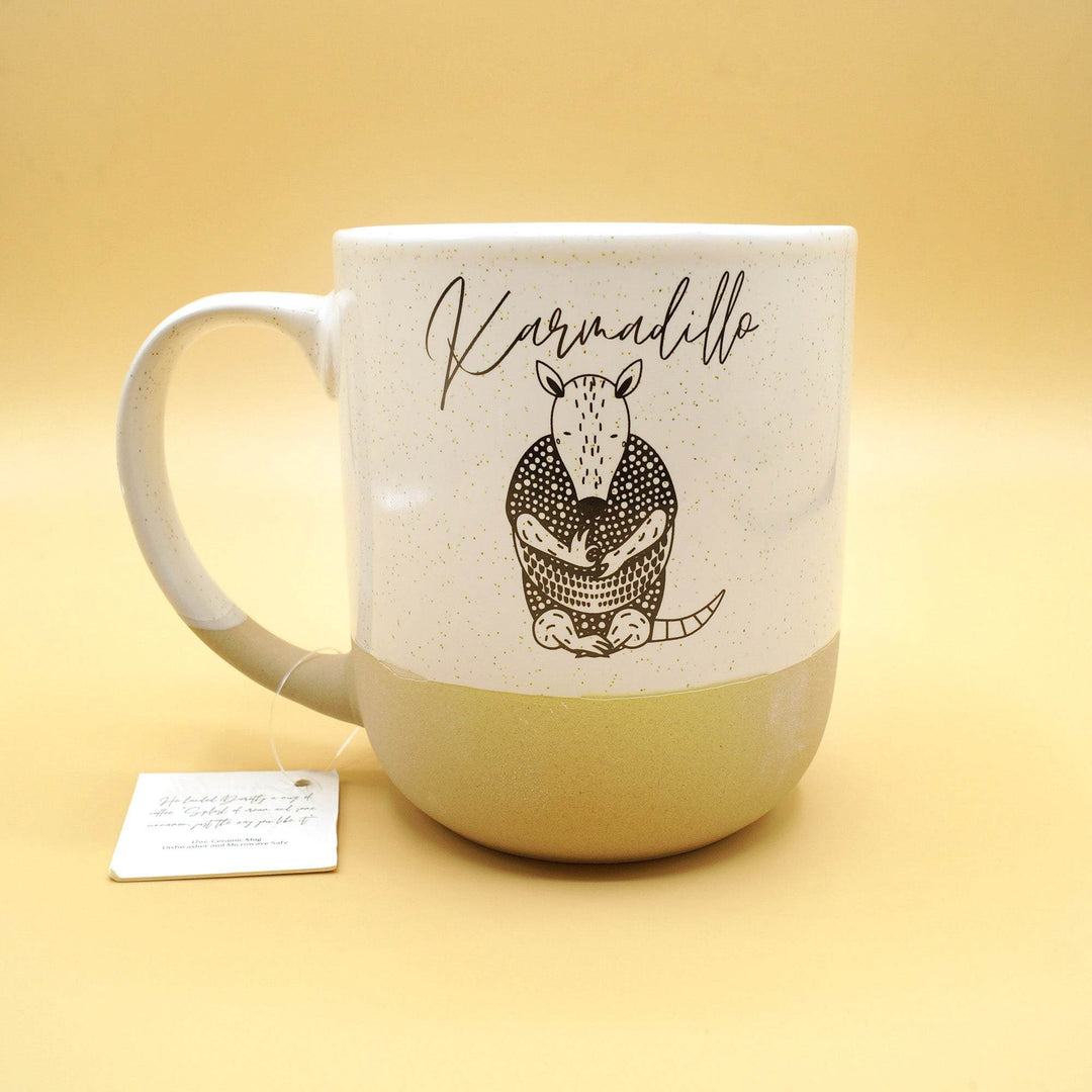 a white mug labeled "Karmadillo" with an image of an armadillo