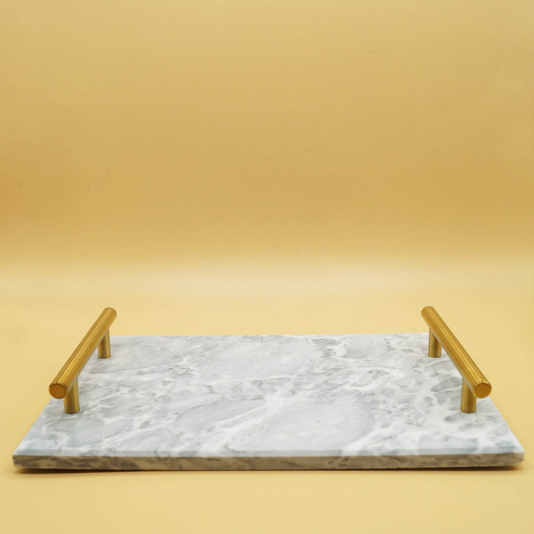 a gray marble serving tray with gold handles