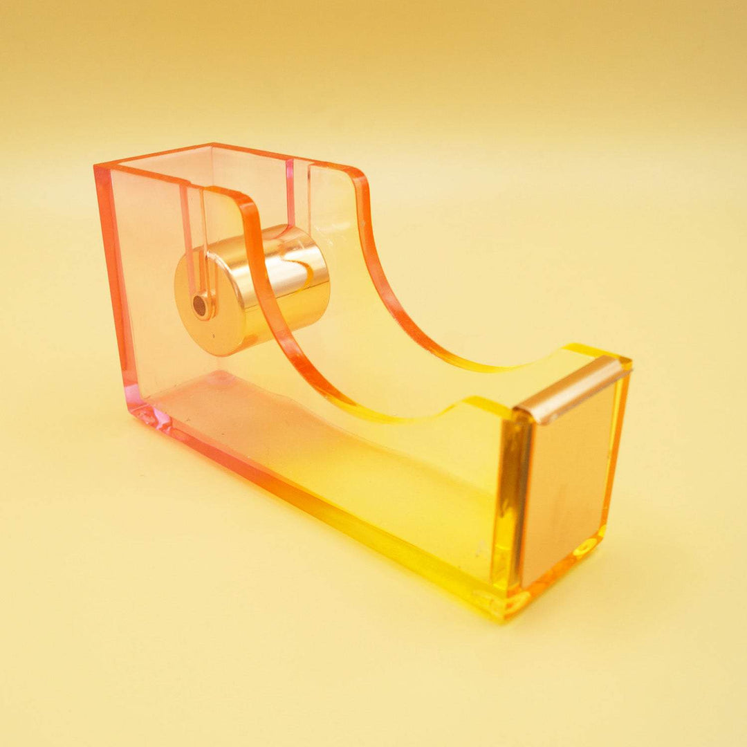 an empty tape dispenser that is an ombre of pink and yellow