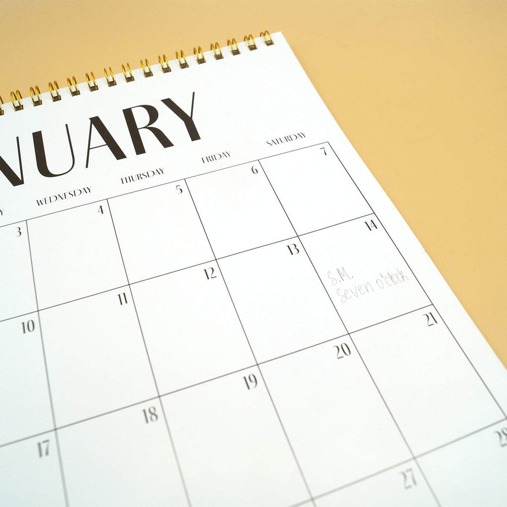 the monthly view of a wall calendar showing empty squares labeled with days