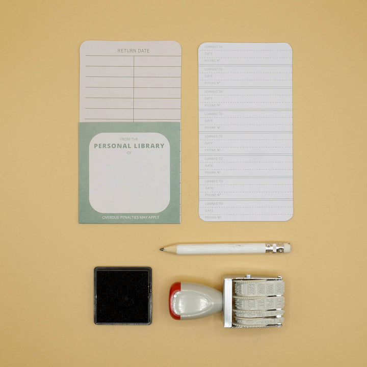 a personal library kit with library cards, date stamp, ink pad, and pencil
