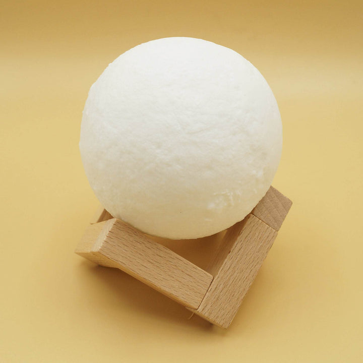 a white-colored moon light on a wooden stand