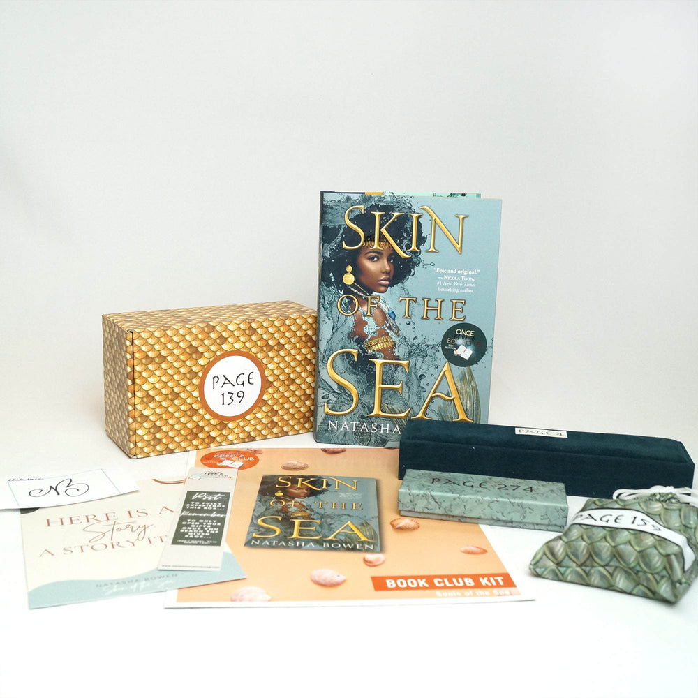 A hardcover edition of Skin of the Sea is next to a yellow box. In front of those are a signature card, quote card, bookmark, bookclub kit, teal felt necklace box, teal box, and green drawstring bag. The boxes and bags all have page numbers.