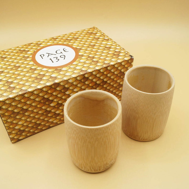 a pair of wooden cups is next to a gold box labeled Page 139