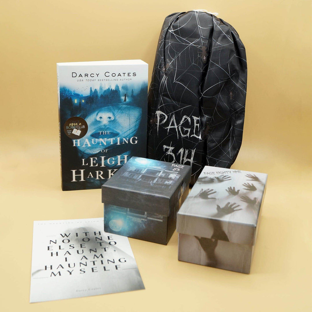 a paperback edition of The Haunting of Leigh Harker next to a black drawstring bag. In front are a black box, a gray box with black handprints, and a quote card. The boxes and bag are all labeled with page numbers.