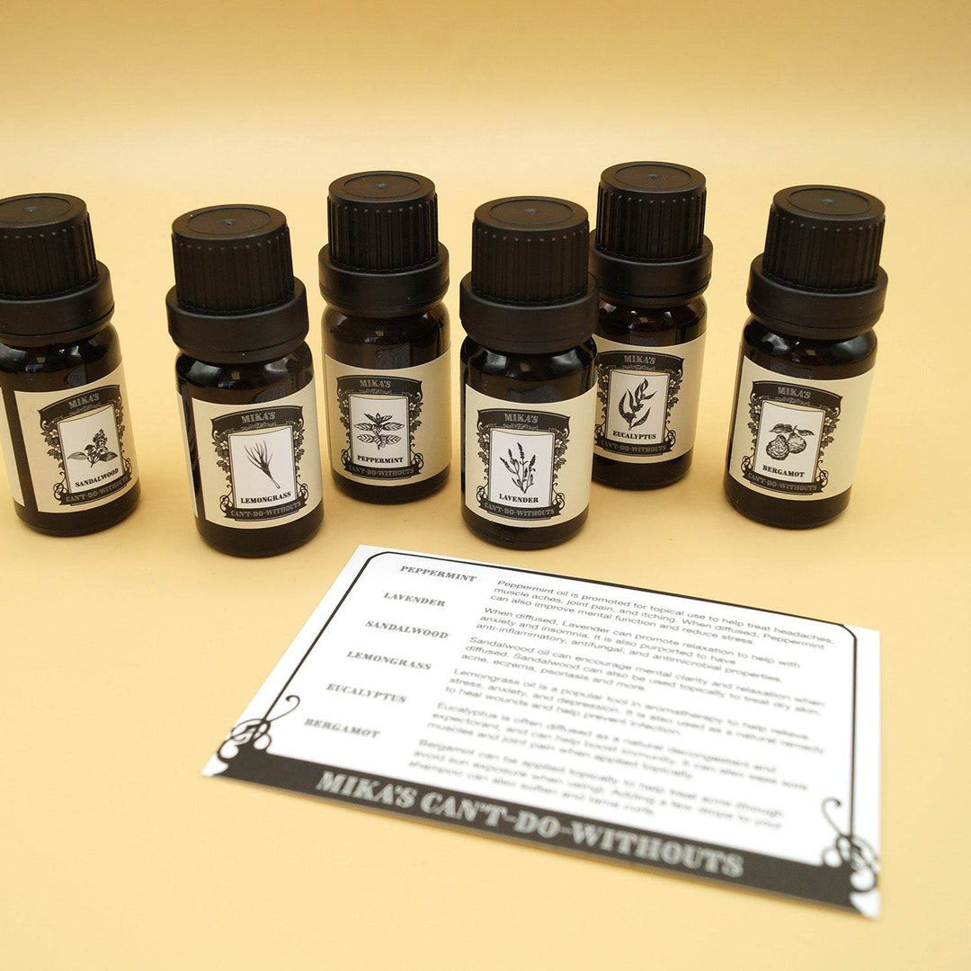 a set of 6 essential oils stand in a line behind a white information card