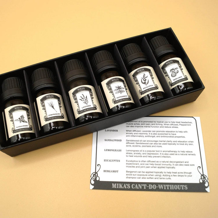 a box of six essential oils lays open next to a white information card