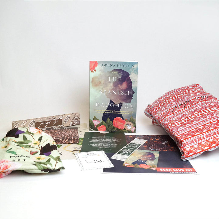 A paperback edition of The Spanish Daughter is centered in the image. In front of the book are a green drawstring bag, two brown boxes, quote card, signature card, bookmark, bookclub kit, and red polybag. The boxes and bags all have page numbers.