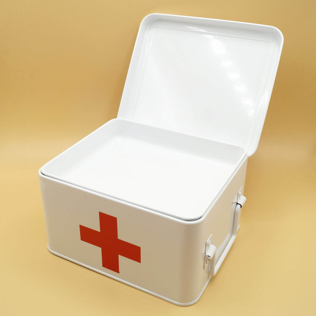 an open white metal first aid box with a red cross on the front