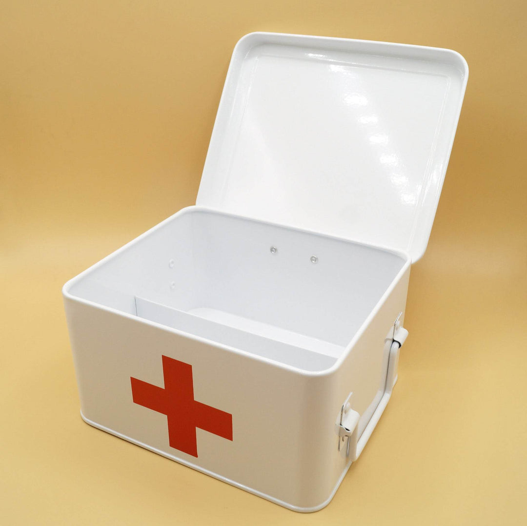 an open white metal first aid box with a red cross at the front