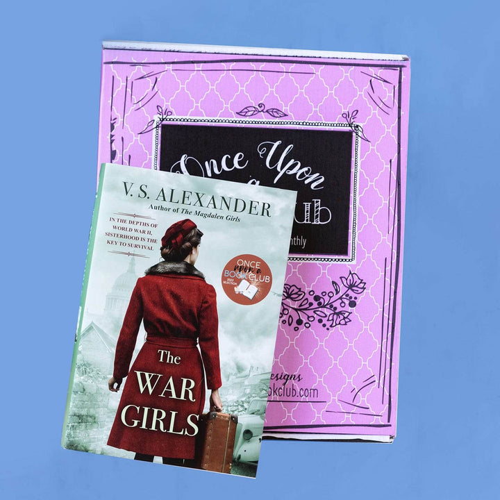 a hardcover special edition of The War Girls by VS Alexander lays on a pink Once Upon a Book Club box. The cover shows a woman in a red coat facing away