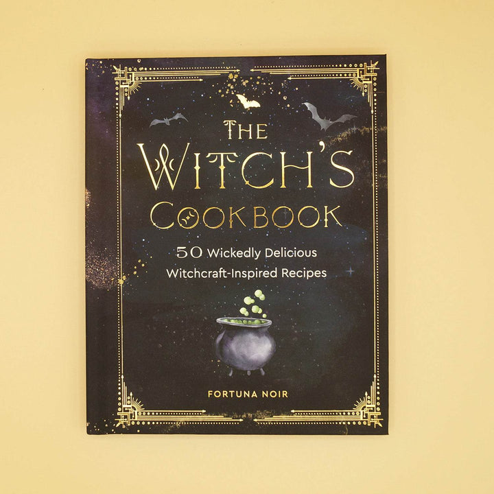 a hardcover edition of The Witch's Cookbook - 50 Wickedly Delicious Witchcraft-Inspired Recipes by Fortuna Noir