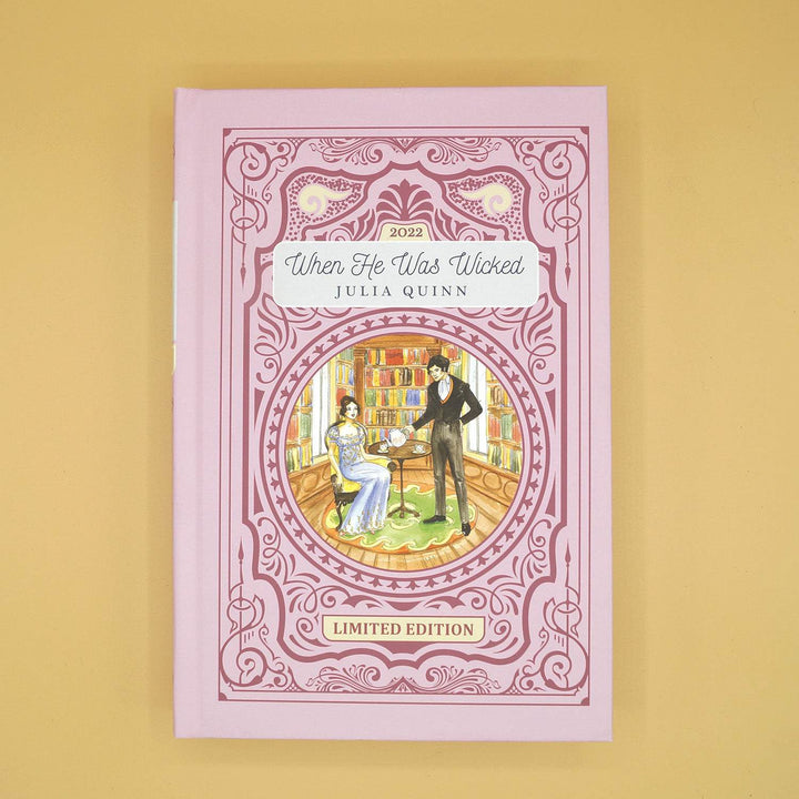 a pink hardcover special edition of When He Was Wicked by Julia Quinn