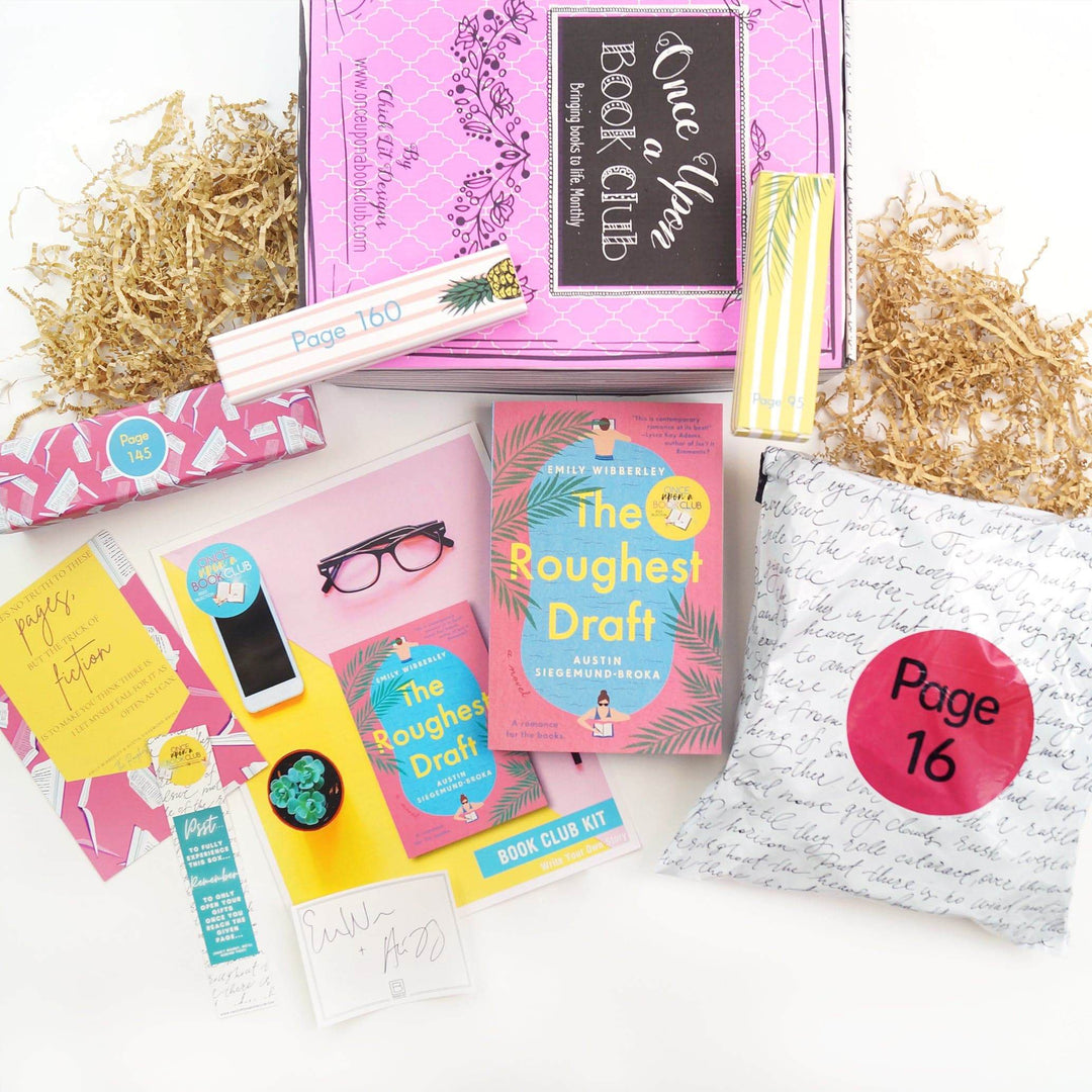 A pink and white box and yellow and white box are on a pink Once Upon a Book Club box. In front of the box are a pink box, quote card, bookmark, bookclub kit, signature card, paperback edition of The Roughest Draft, and a white polybag. The boxes and bags all have page numbers.